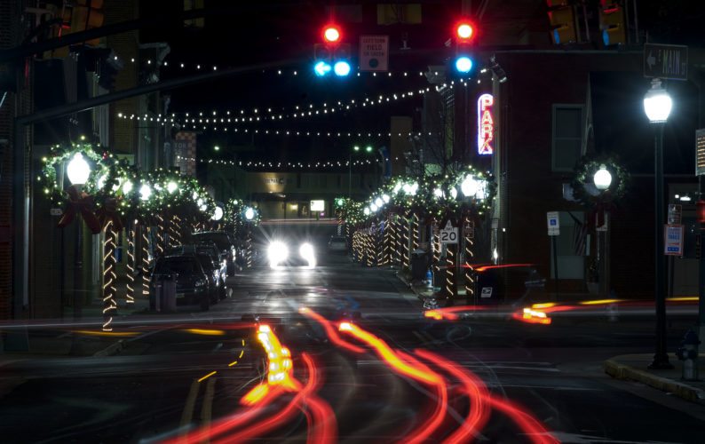 Car tail lights illuminate this scene onto Front Royal's Main Street with Christmas lights lining the streets. Rich Cooley/Daily